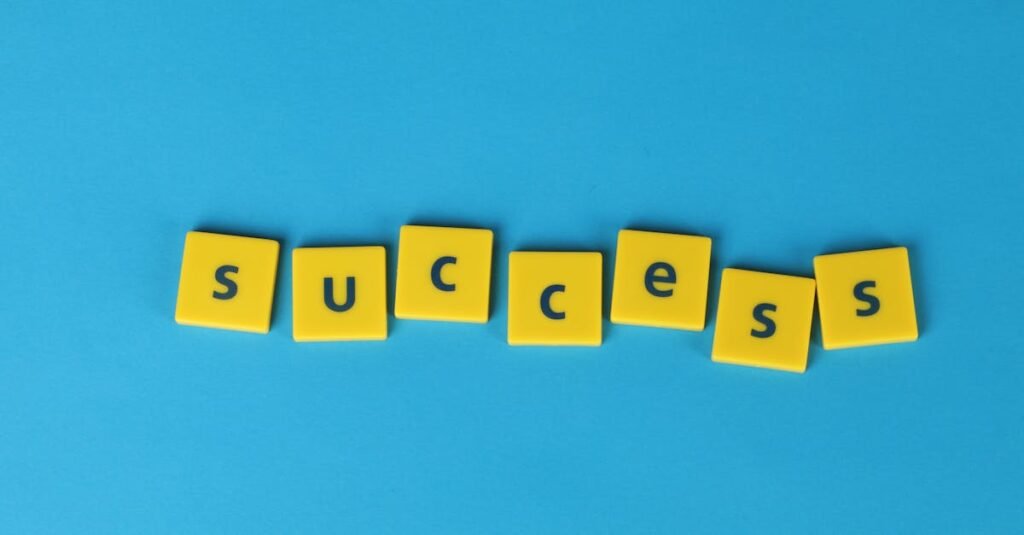 Yellow letter tiles spell the word success on a vibrant blue backdrop, symbolizing achievement.